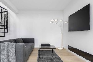 Minimalist,Living,Room,With,Big,Television,Screen,And,Industrial,Style